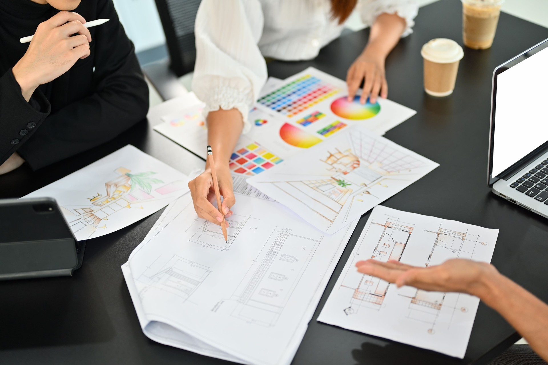Interior designer team brainstorming and planning construction project together at co working space